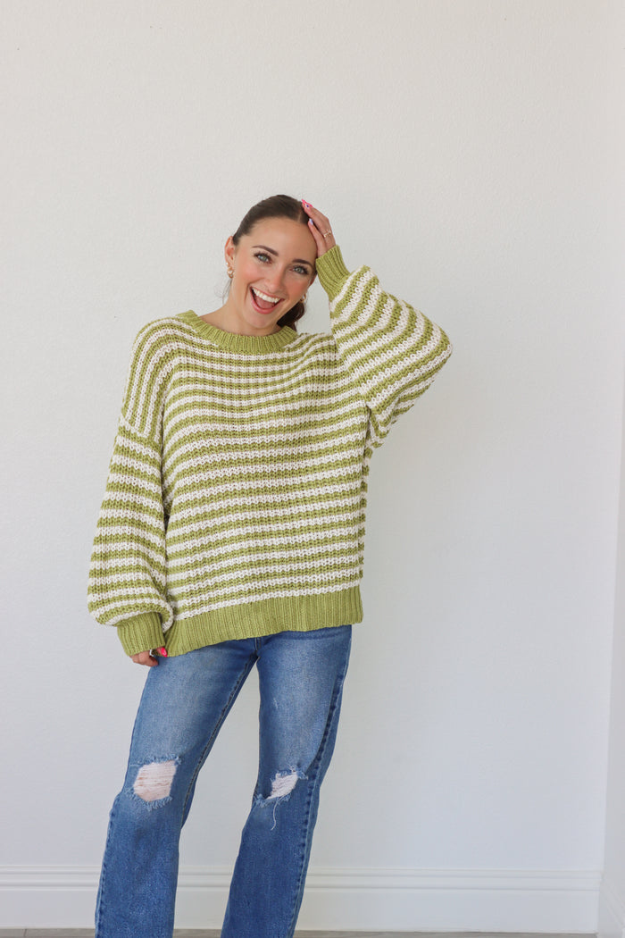 girl wearing lime green and white knit sweater