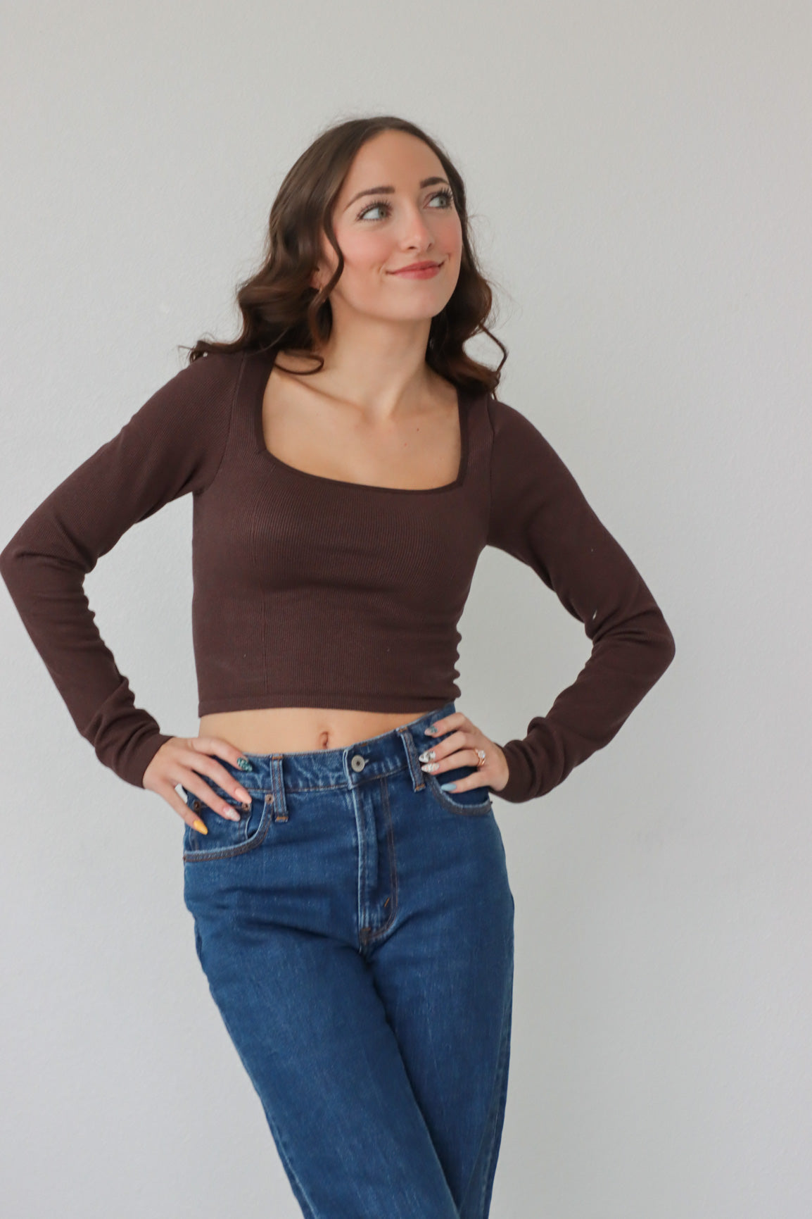 girl wearing brown square neck, long sleeved top