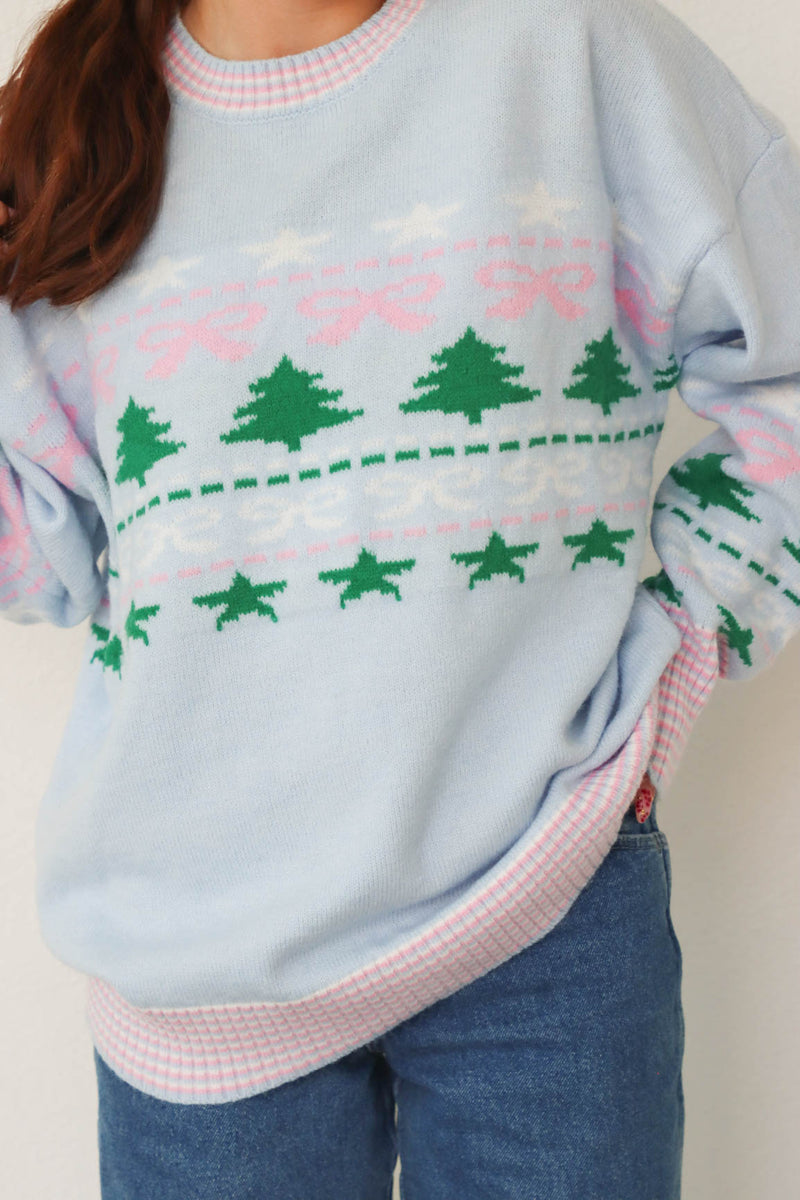 girl wearing light blue holiday sweater