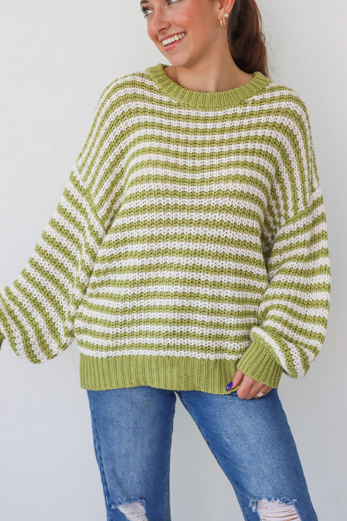 girl wearing lime green and white knit sweater