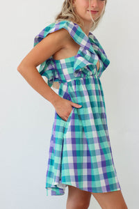 girl wearing blue and purple plaid short dress