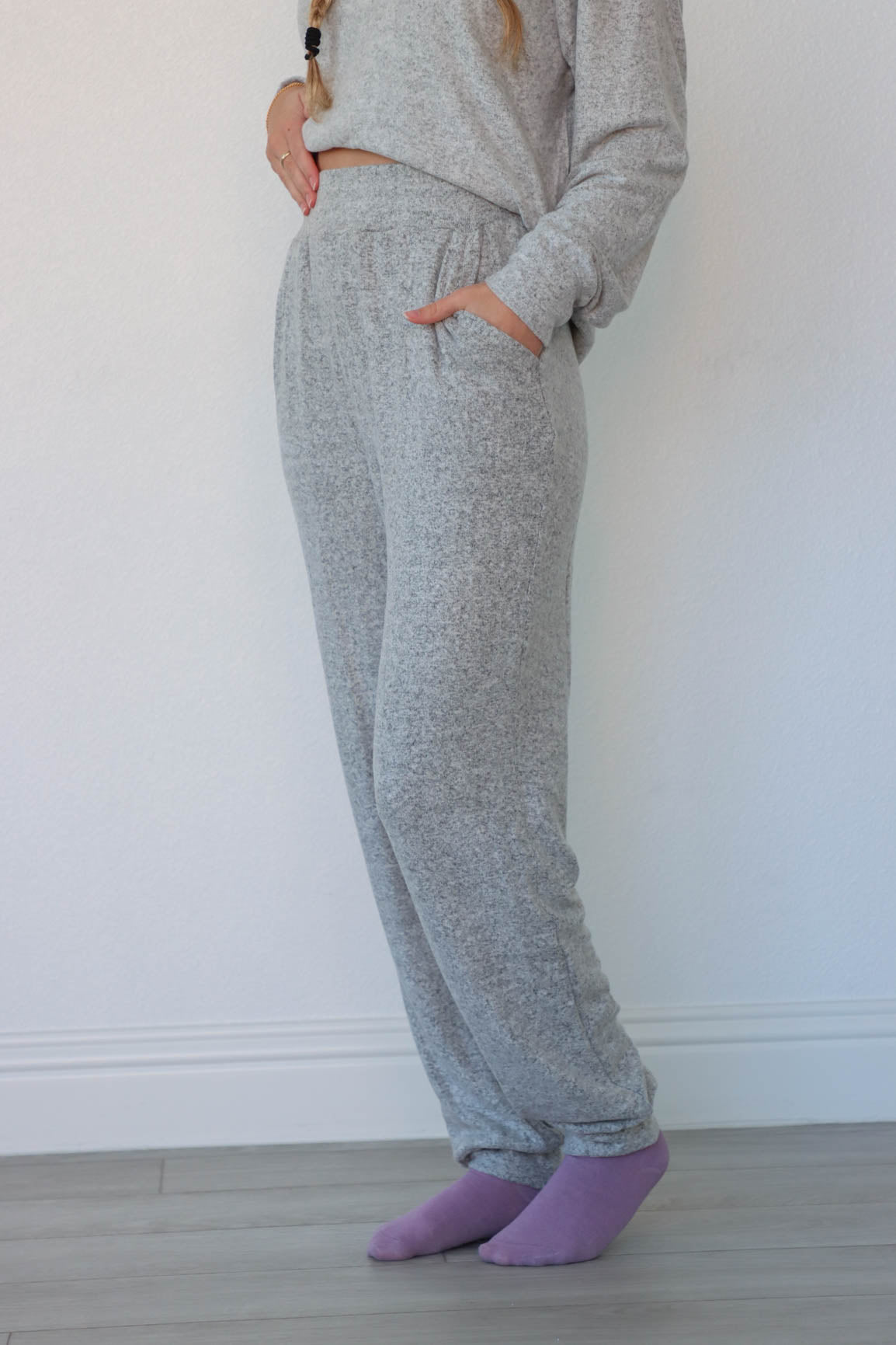 girl wearing heather gray matching lounge set; long sleeve top and pants