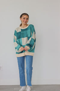girl wearing teal checker print knit sweater