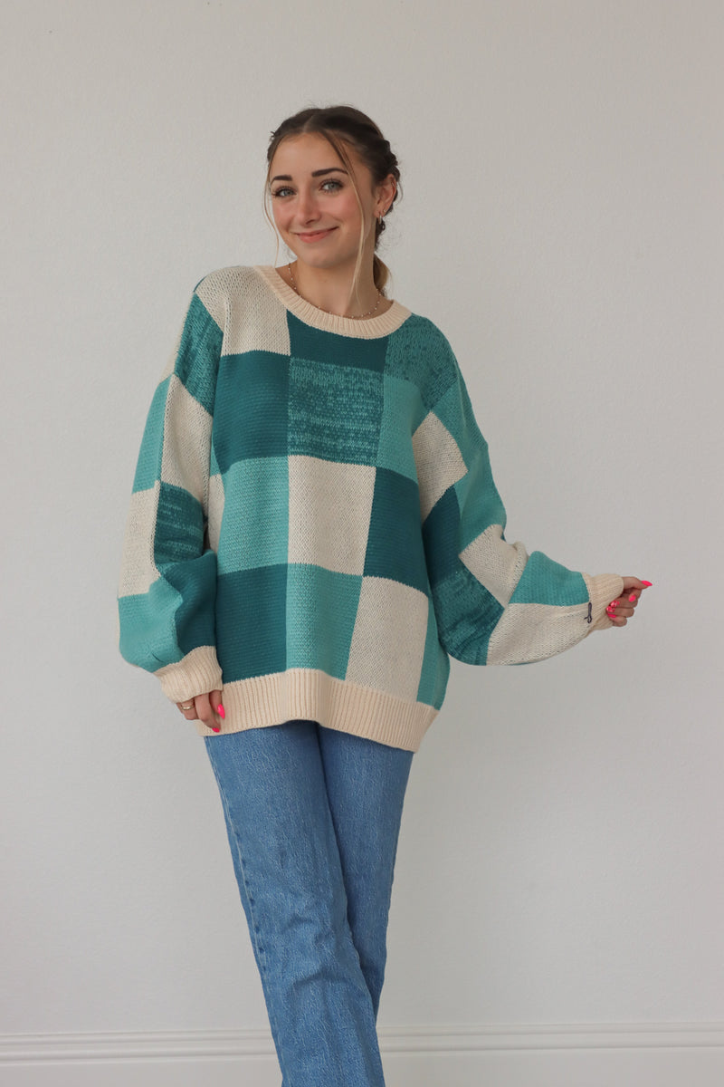 girl wearing teal checker print knit sweater