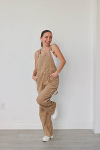 girl wearing tan corduroy overalls