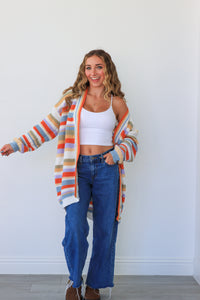 girl wearing multicolor knit striped cardigan