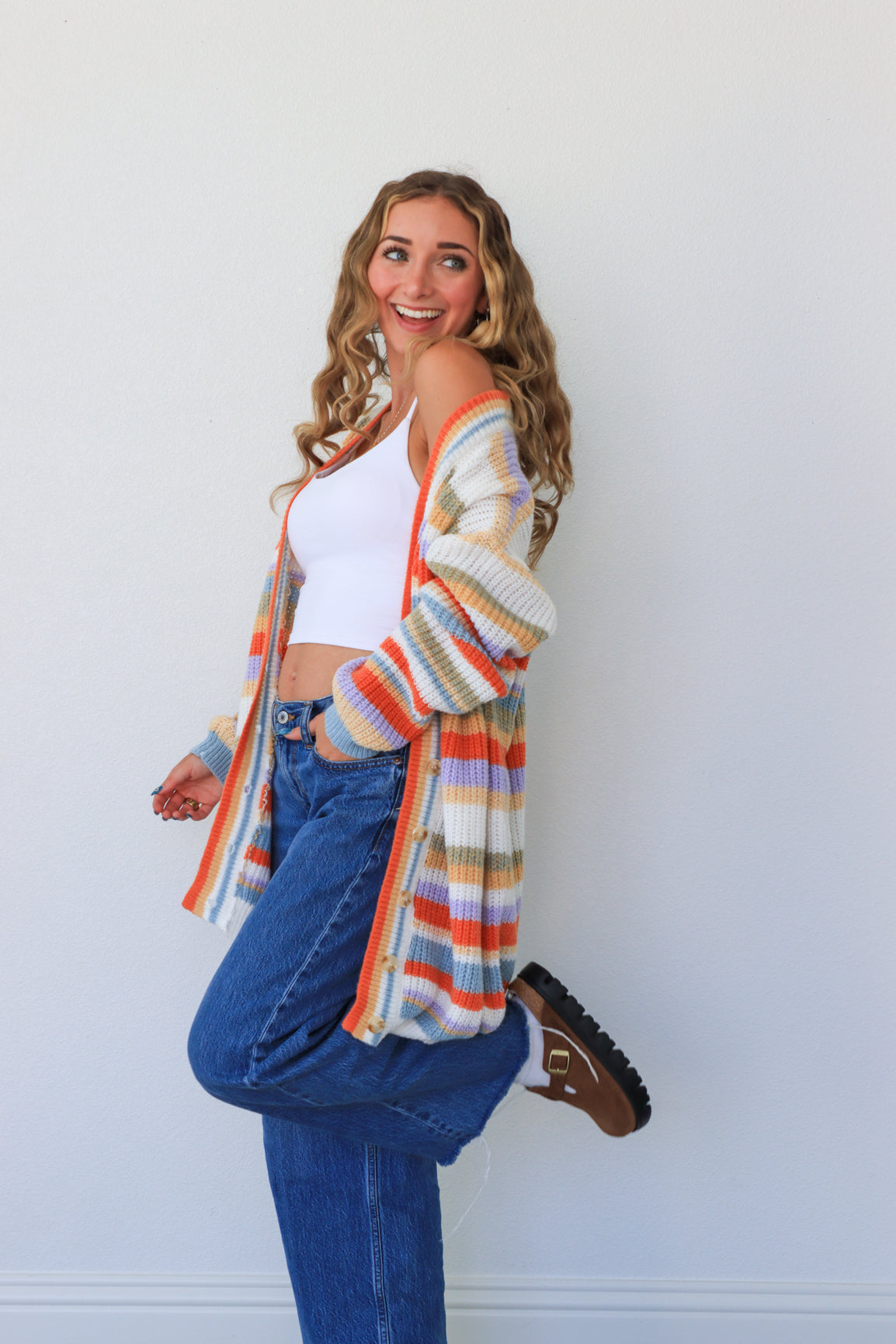 girl wearing multicolor knit striped cardigan