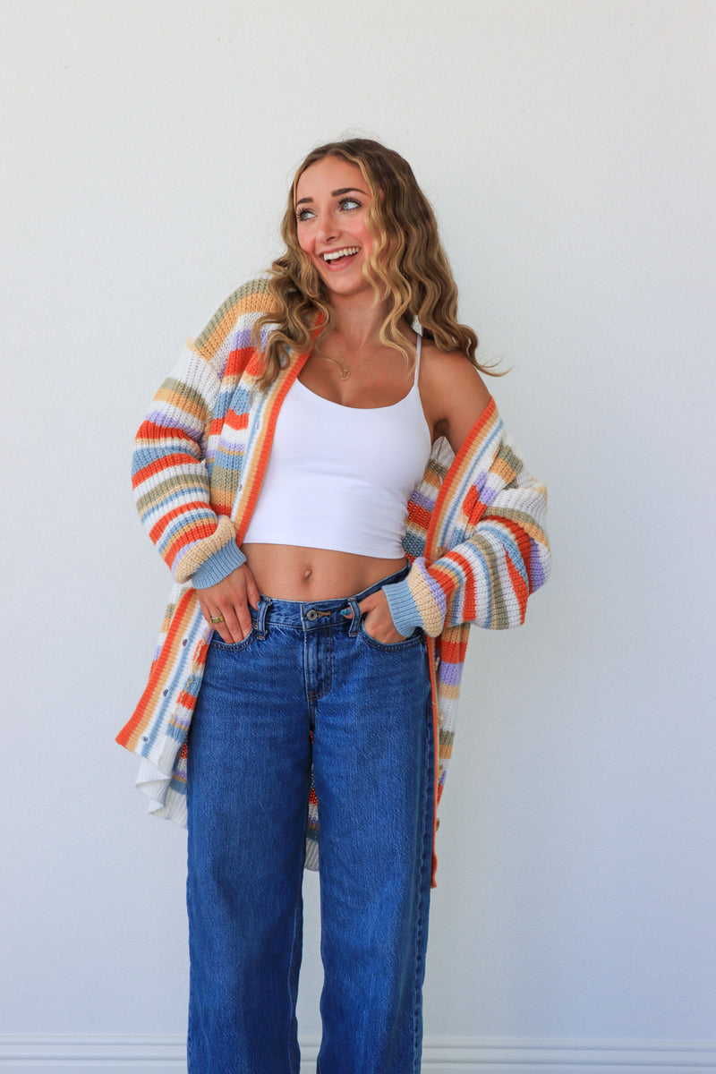 girl wearing multicolor knit striped cardigan