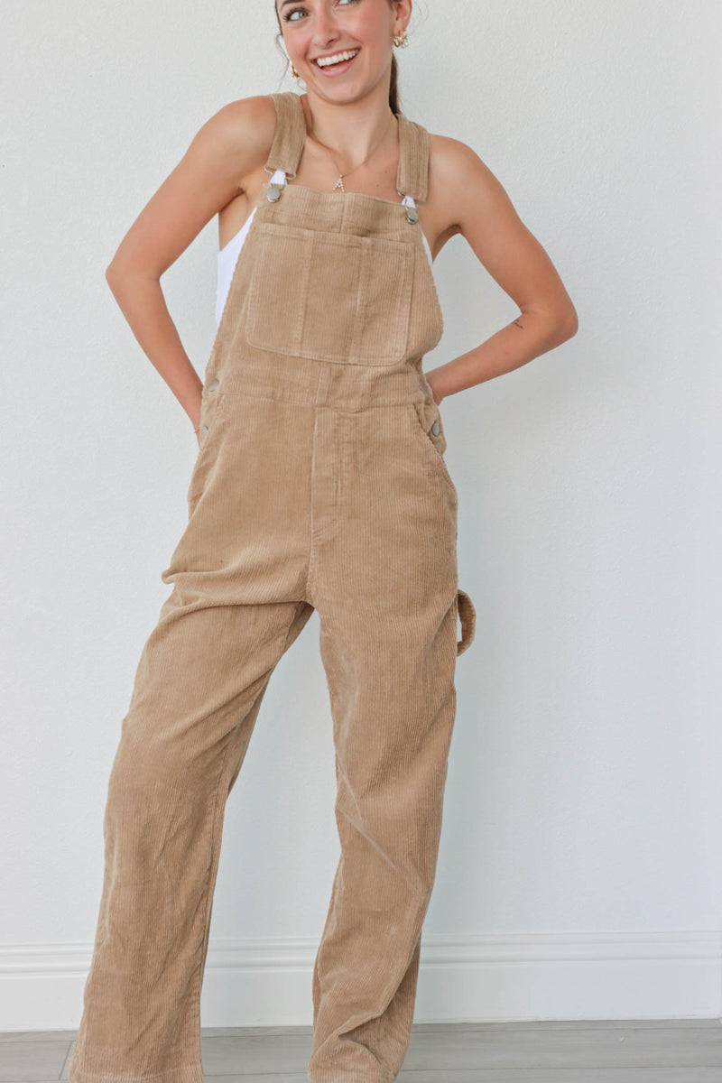 girl wearing tan corduroy overalls