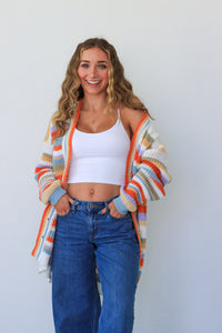 girl wearing multicolor knit striped cardigan