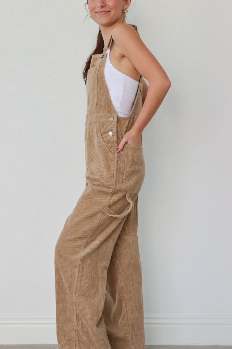 girl wearing tan corduroy overalls