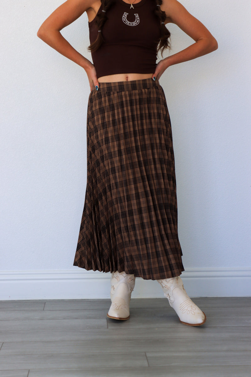 woman wearing dark brown plaid midi skirt