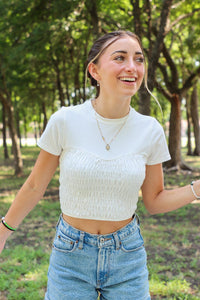 girl wearing white ruched short sleeve shirt