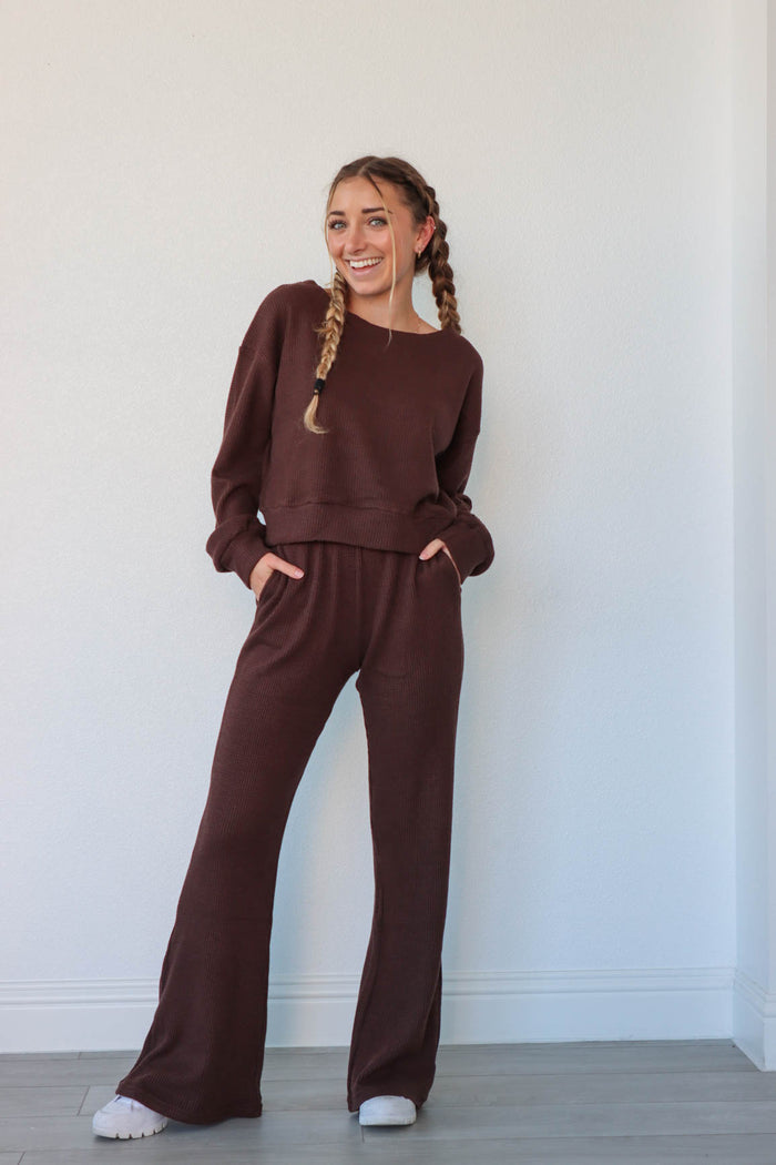 girl wearing chocolate brown waffle knit matching lounge set; long sleeve top and pants