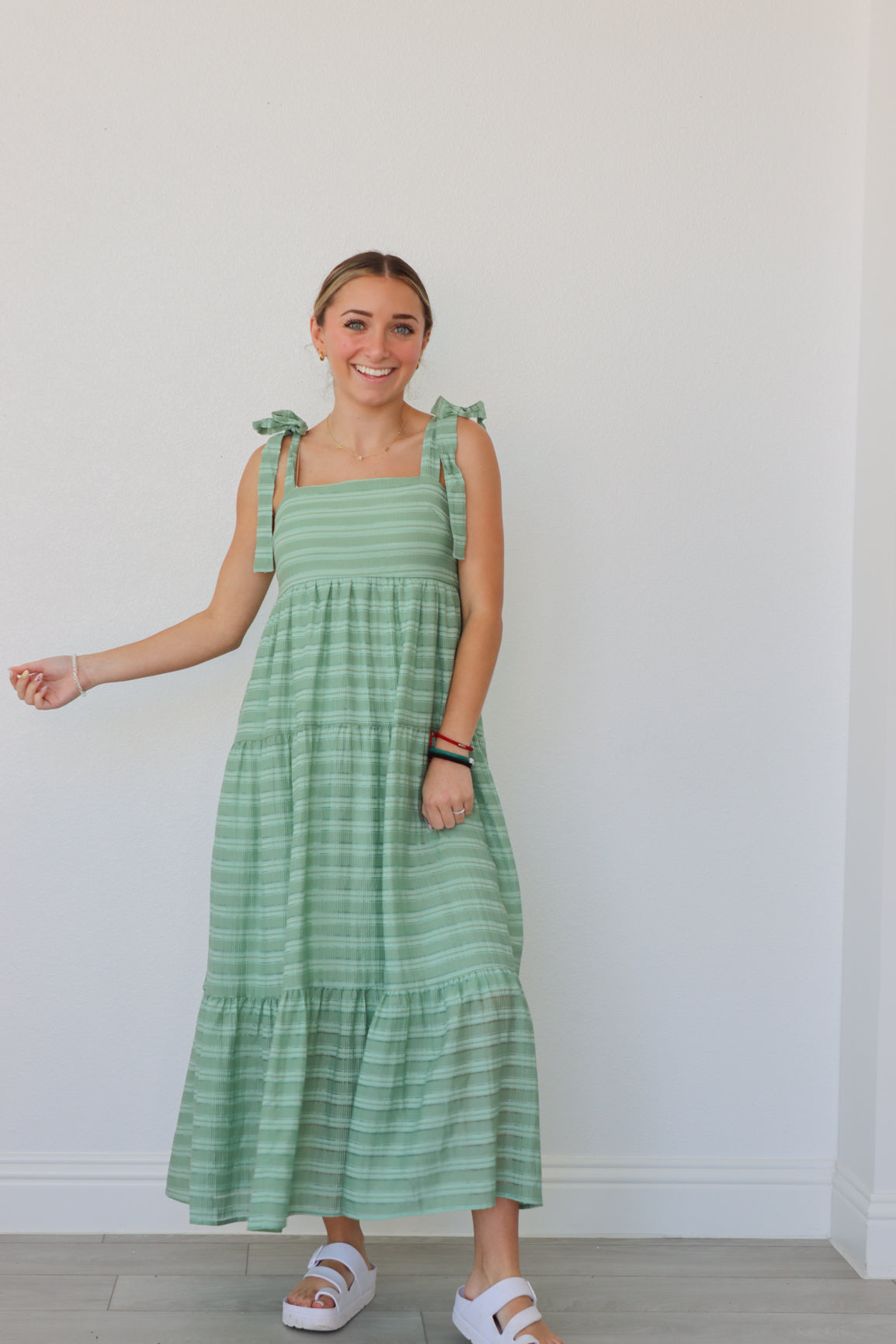 girl wearing green striped maxi dress