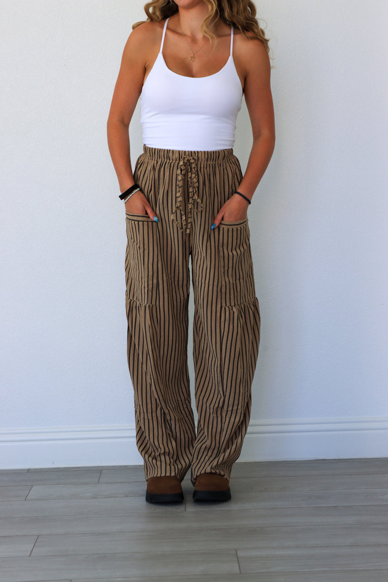 woman wearing brown pinstripe pants