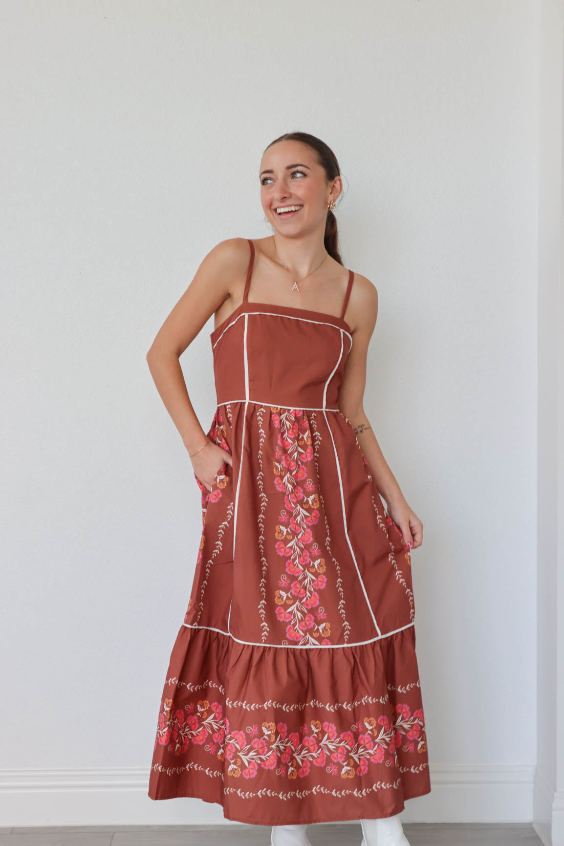 girl wearing dark orange maxi floral dress