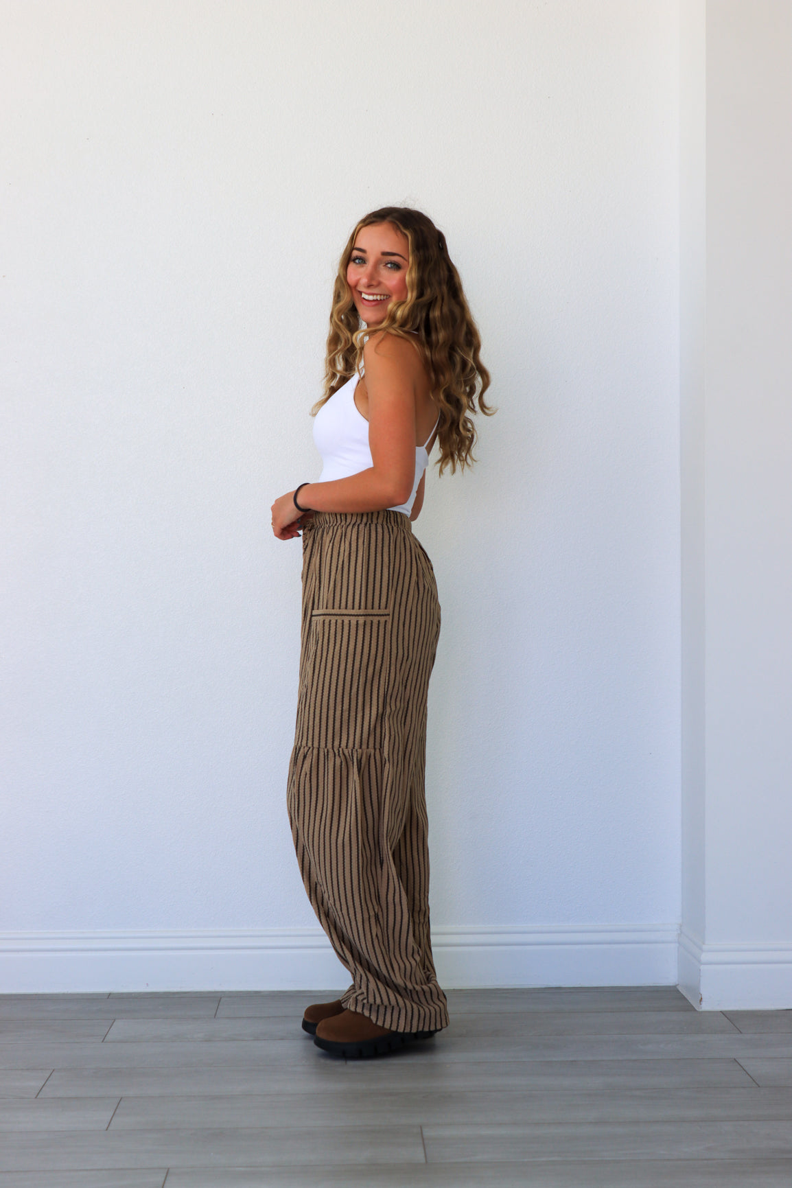woman wearing brown pinstripe pants