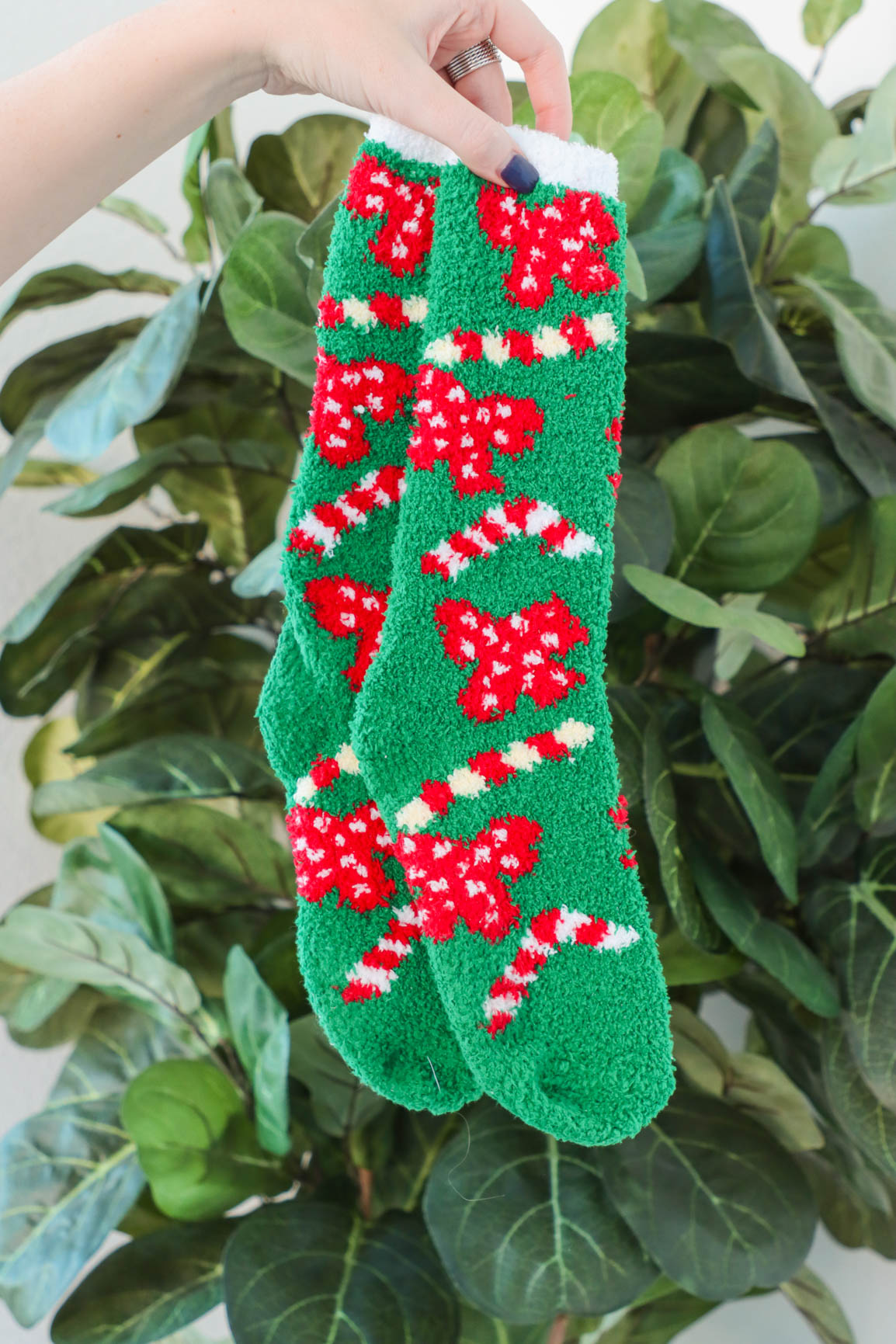green fuzzy christmas socks with candy canes and bows