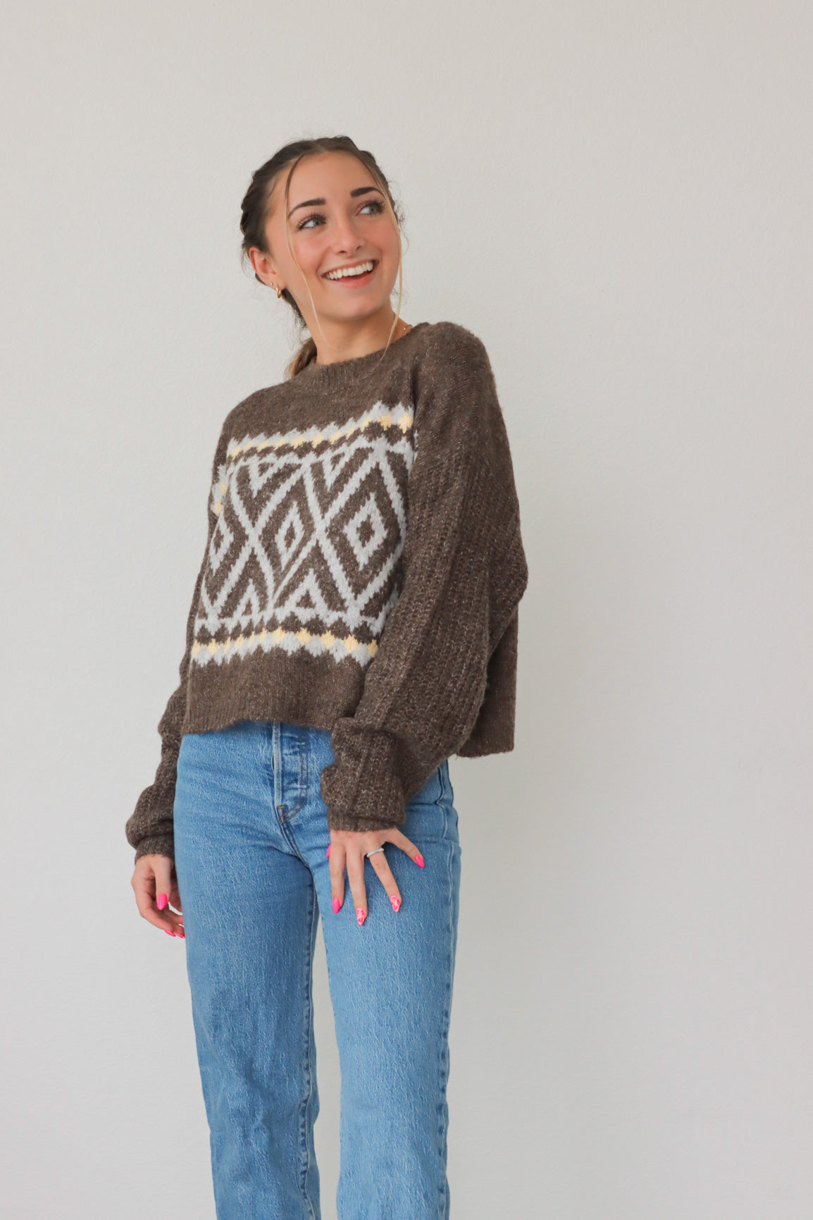 girl wearing brown knit sweater with light and cream detailing