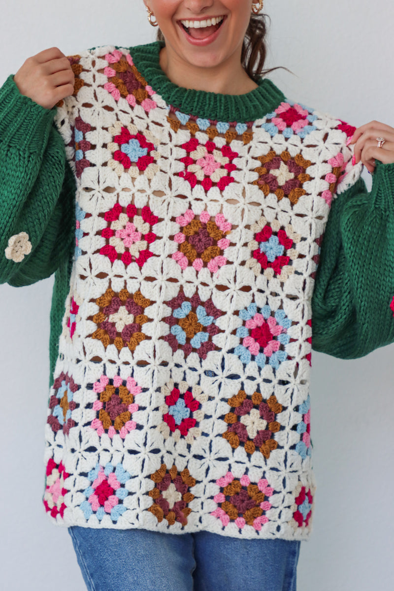 girl wearing green and cream crochet sweater