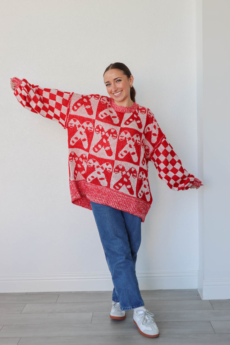 girl wearing white and red candy cane sweater