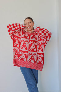 girl wearing white and red candy cane sweater