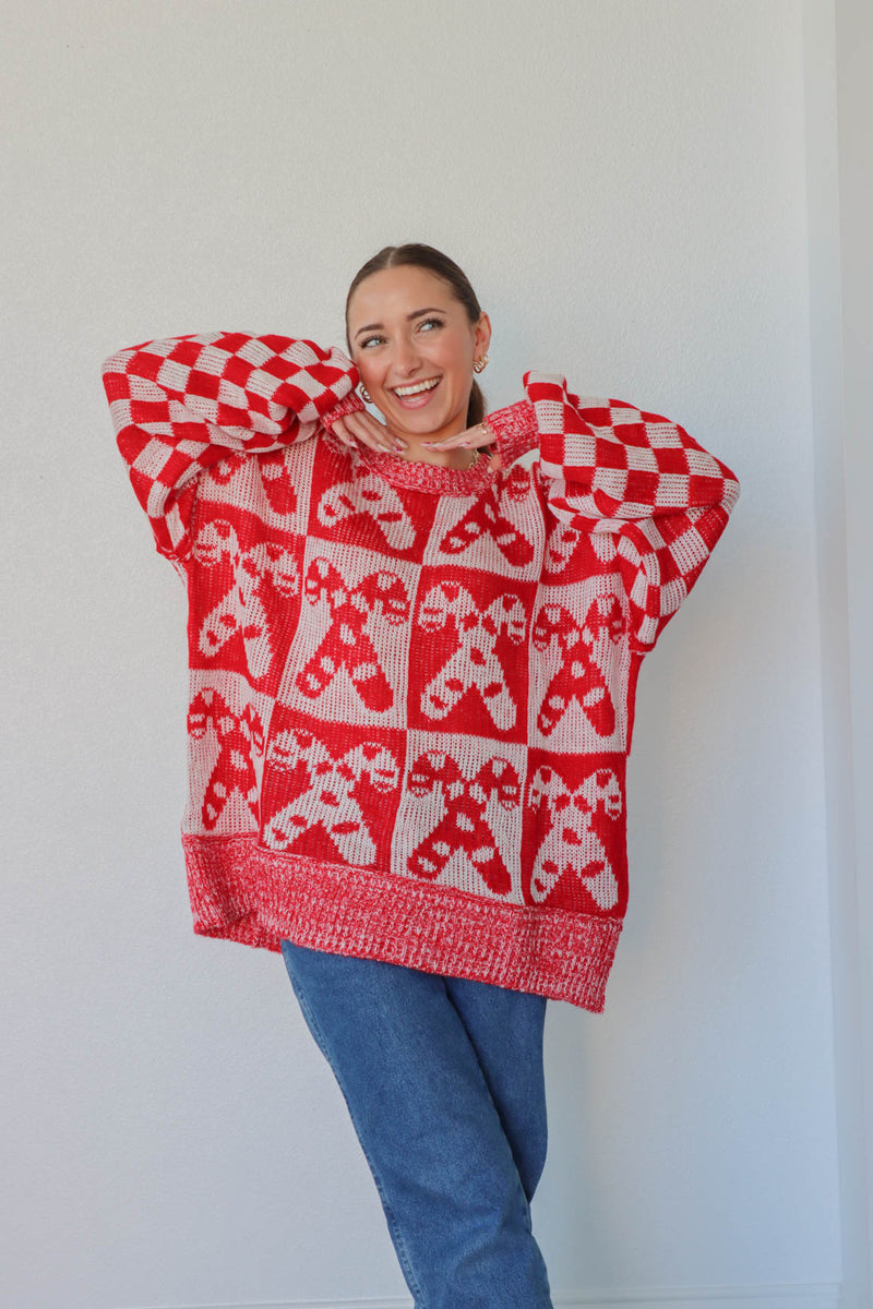 girl wearing white and red candy cane sweater