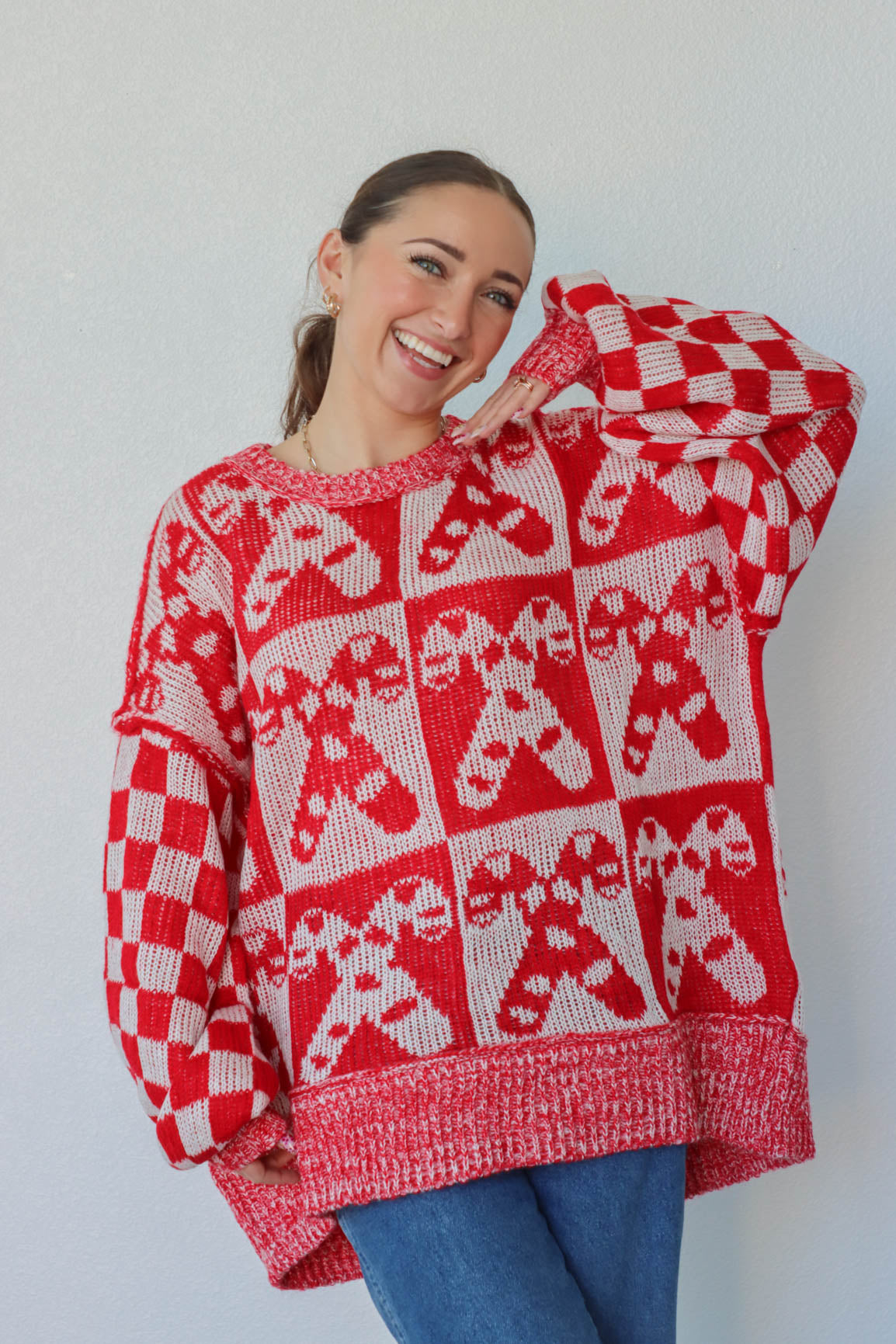 girl wearing white and red candy cane sweater