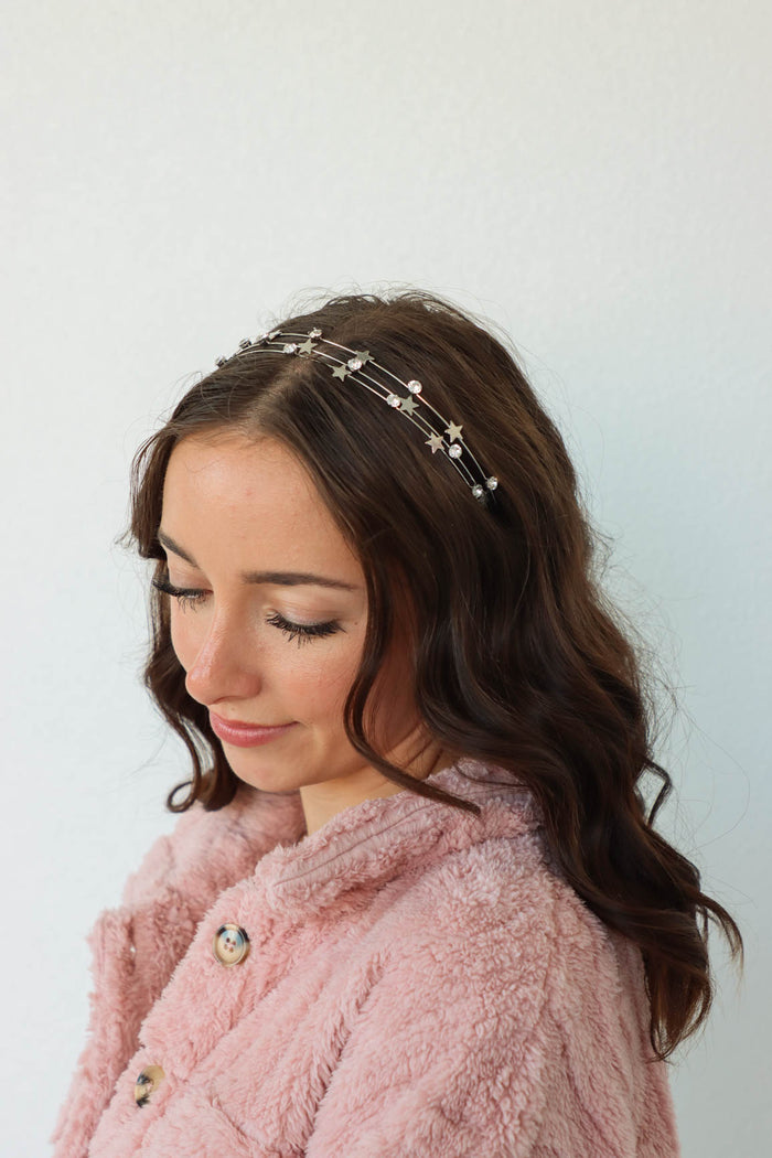 girl wearing silver star and rhinestone headband