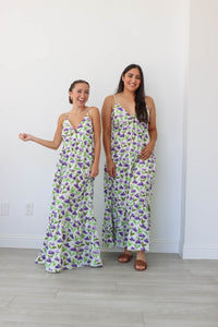 two girls wearing the same white floral maxi dress