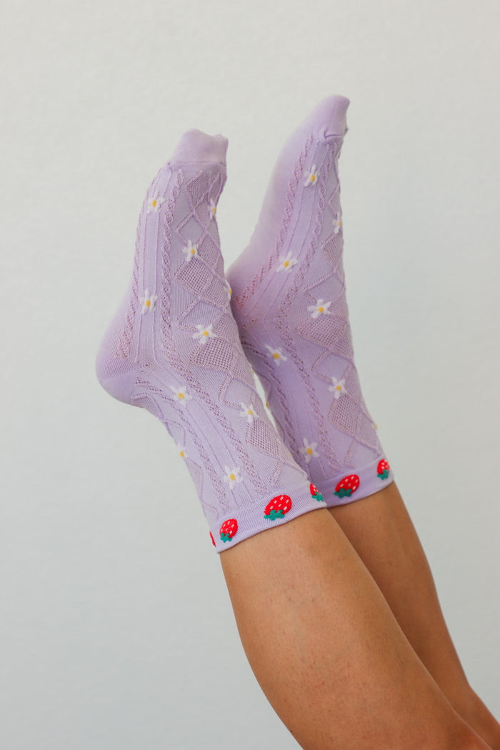girl wearing purple strawberry socks