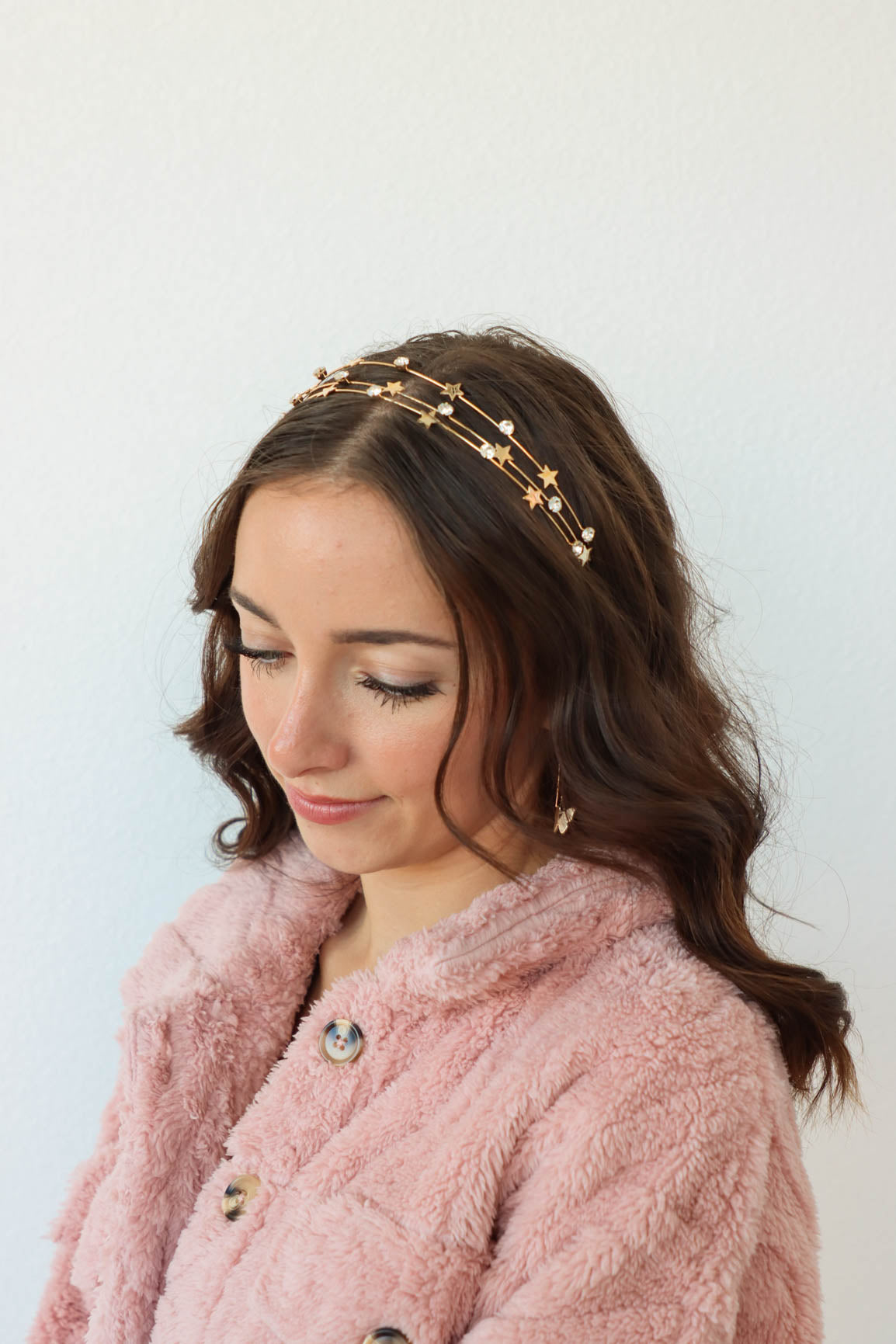 girl wearing gold star and rhinestone headband