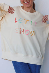 girl wearing cream "let it snow" top