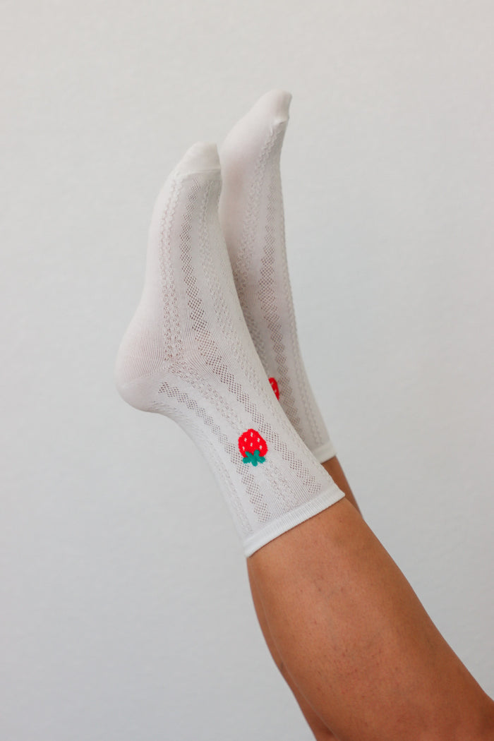girl wearing white strawberry socks