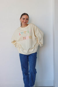 girl wearing cream "let it snow" top