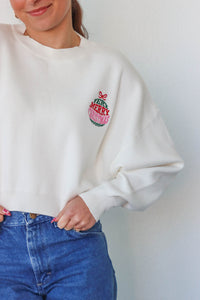 girl wearing white "very merry christmas" sweater