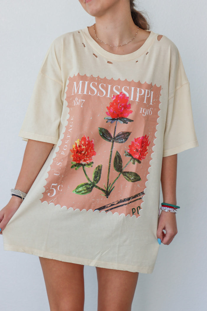 girl wearing cream t-shirt with vintage mississippi postage stamp graphic
