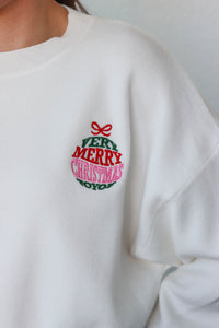 girl wearing white "very merry christmas" sweater