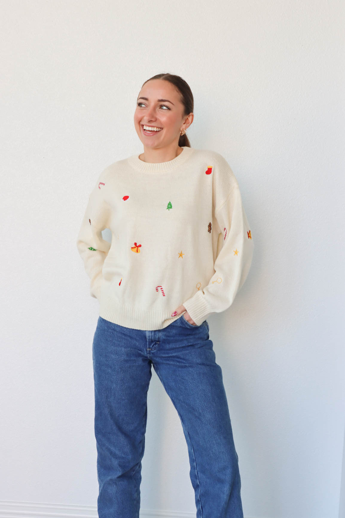 girl wearing cream embroidered holiday sweater