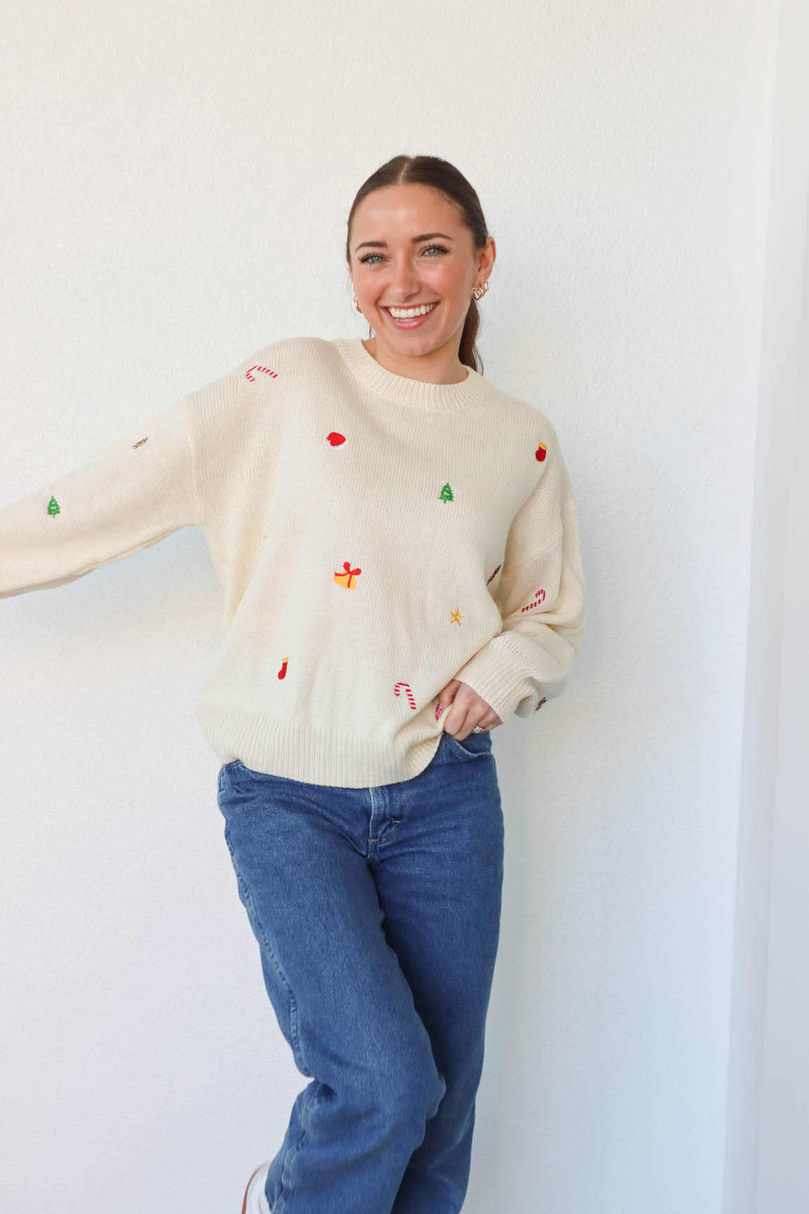 girl wearing cream embroidered holiday sweater