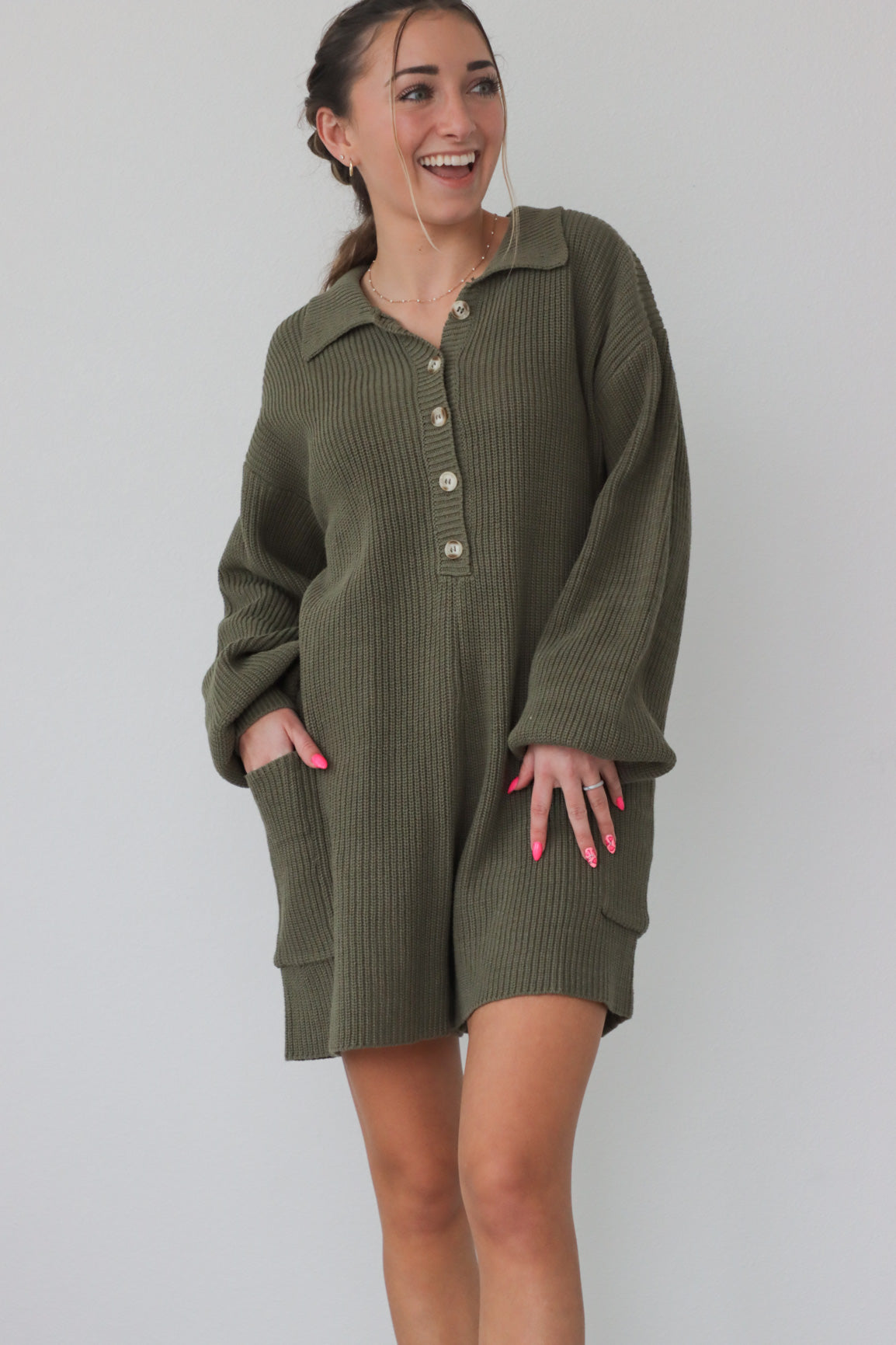 girl wearing olive green knit, long sleeved romper