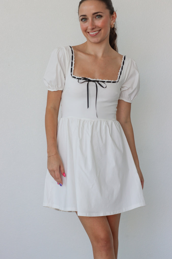 girl wearing white short babydoll dress