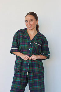 girl wearing dark green plaid pajamas