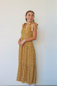 girl wearing long yellow floral dress