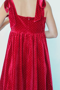 girl wearing red velvet dress with rhinestone detailing