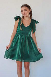 girl wearing short green satin green dress