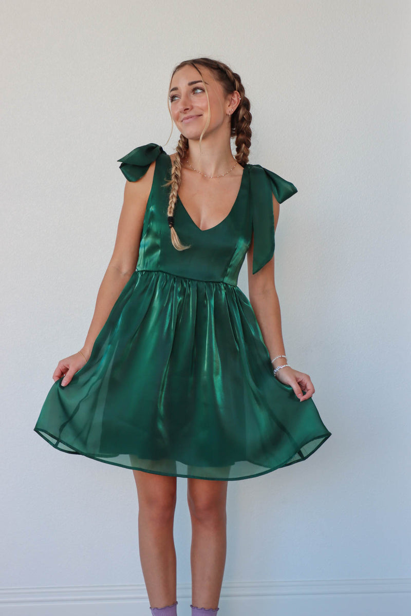 girl wearing short green satin green dress