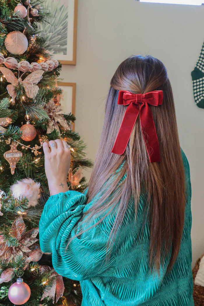 girl wearing red velvet hair bow clip