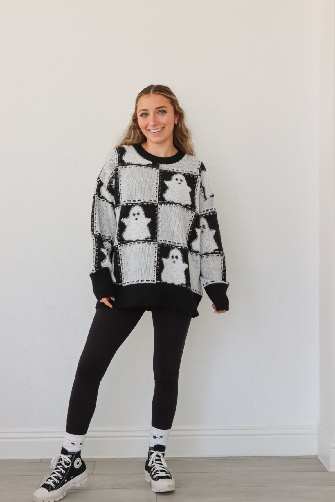 girl wearing black & white ghost sweater